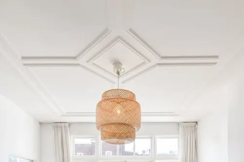 Decorative ceiling trim and crown molding detail in a bright residential room
