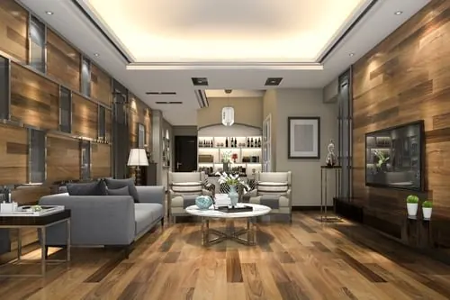 Warm wide-plank wood flooring installed through an open living and dining space