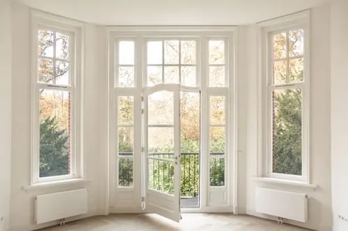 Bright room with newly installed bay windows and white painted interior trim