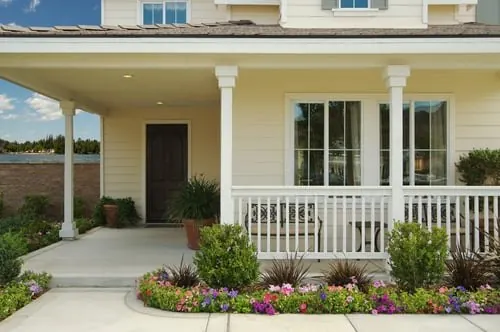 Craftsman-style home exterior with fresh siding, porch columns, and painted trim